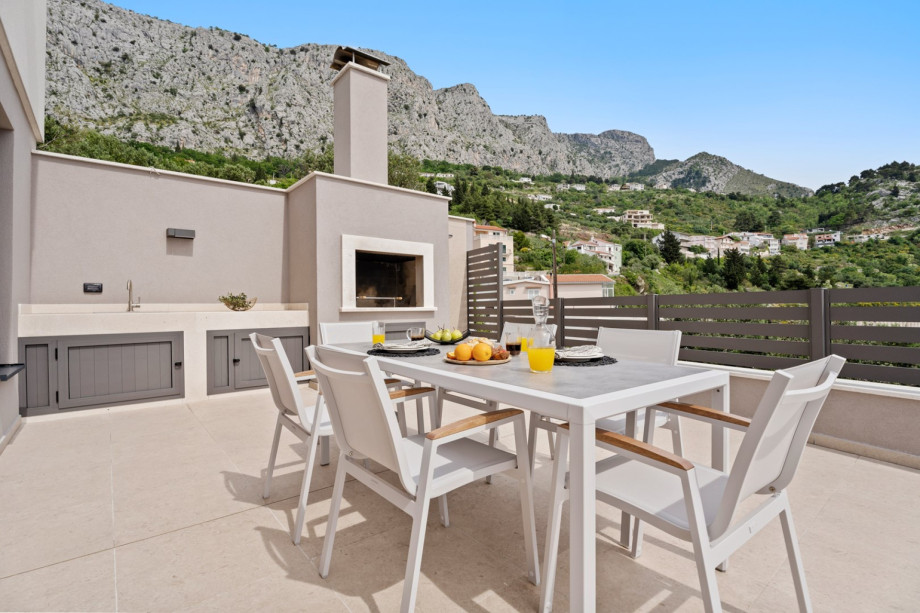 Outdoor dining area with a barbecue Grill, and magnificent sea views