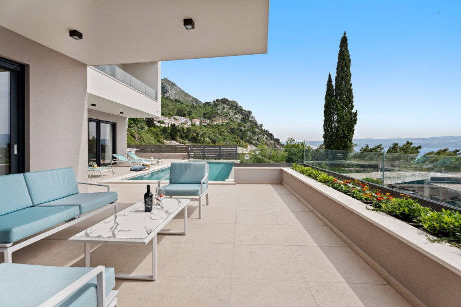 The outdoor sitting area is next to the pool