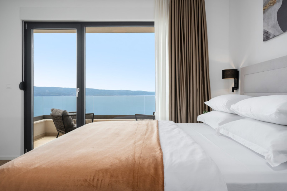 Bedroom NO1 with an 8 sqm balcony with a table and two chairs, is a perfect spot for enjoying romantic sunsets with a glass of wine.