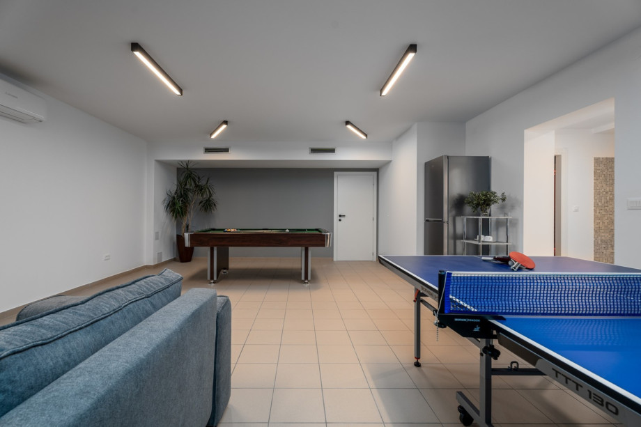 Play zone with a sofa, PlayStation 4, JBL speaker, a Billiard (Pool table), Table tennis, and a fridge for refreshments.