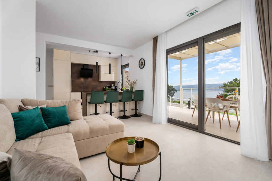 A living room area with a flat-screen TV, a sofa (can convert into a sofa bed), a free WiFi