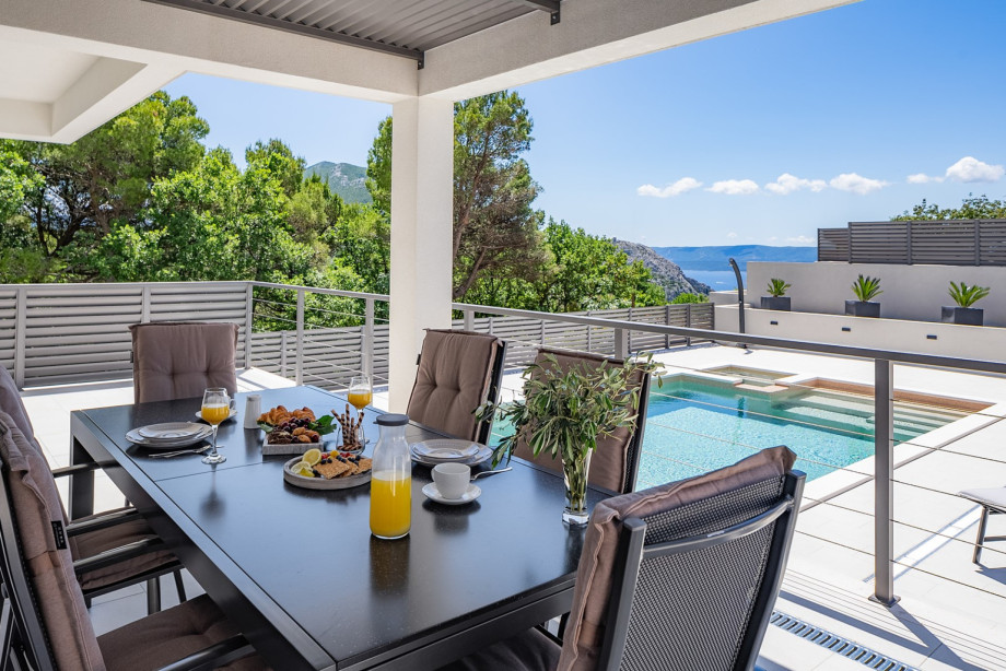 An outdoor table set for a romantic breakfast features a charming, intimate atmosphere