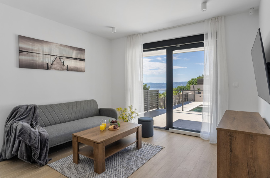 The second living room on the ground floor with a TV, air conditioning