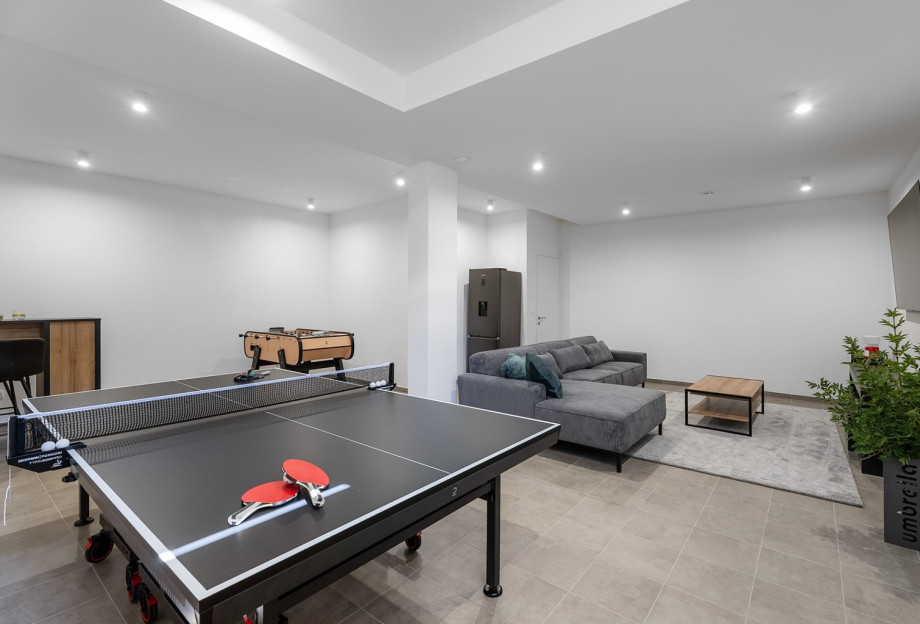 Fun Zone has a fridge, a bar with four stools, and a PlayStation 5