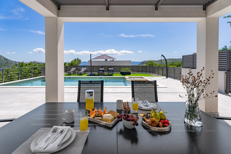 A traditional charcoal/wood barbecue, and outdoor dining table for 6