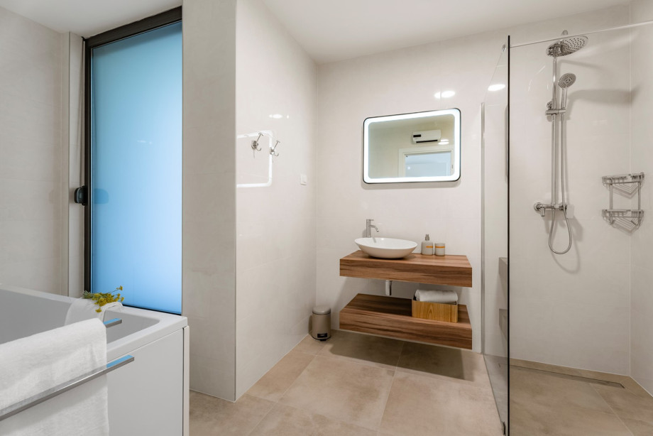 A family restroom featuring a shower and bathtub.