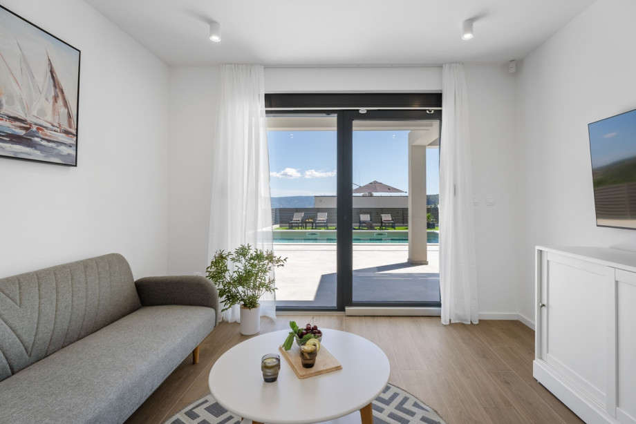 Das zweite Wohnzimmer im Erdgeschoss mit Fernseher, Klimaanlage