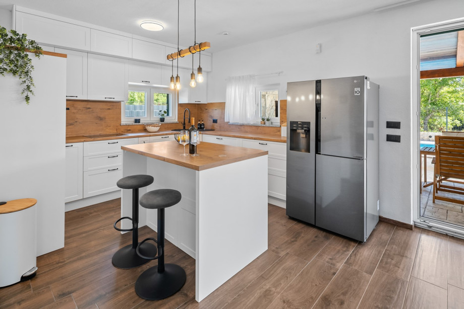 The fully equipped kitchen includes a fridge with an ice maker