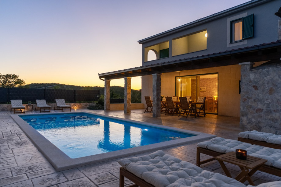 Enjoy the peaceful night outdoors, relaxing on the seating area