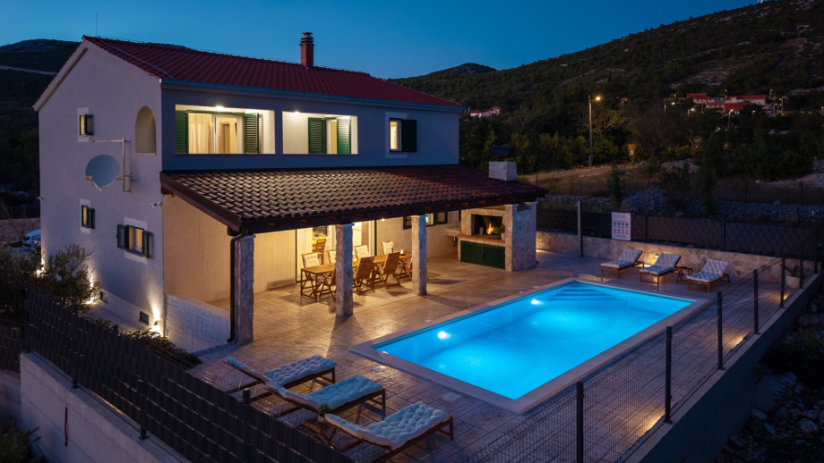 Venture up the outdoor staircase to reach the breathtaking pool area where a heated private swimming pool