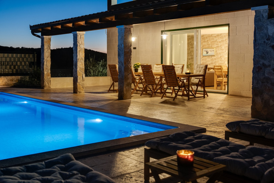 Enjoy the peaceful night outdoors, relaxing on the seating area