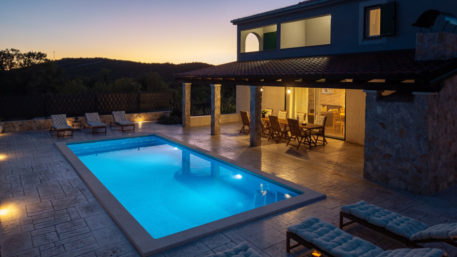 Venture up the outdoor staircase to reach the breathtaking pool area where a heated private swimming pool