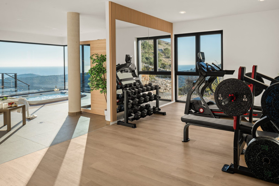A 28sqm Gym offering a multifunctional device, an exercise bike, and pilates equipment