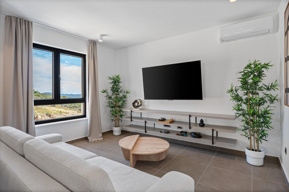 Air conditioning, a TV, a PlayStation 5 console and comfortable sofa that can convert into a sofa bed for two.