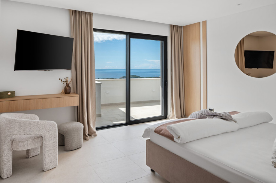 Master Bedroom NO1 is also equipped with air-conditioning, a TV, a balcony and sea views.