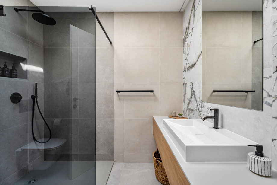 An en-suite bathroom with a shower, a sink, and a toilet