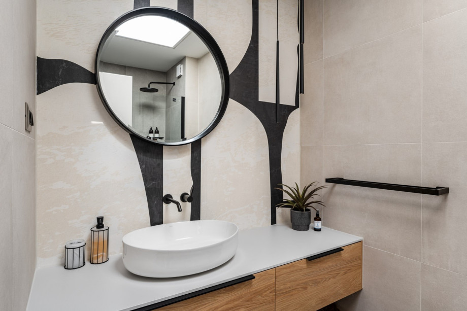 An en-suite bathroom with a shower, a sink, and a toilet