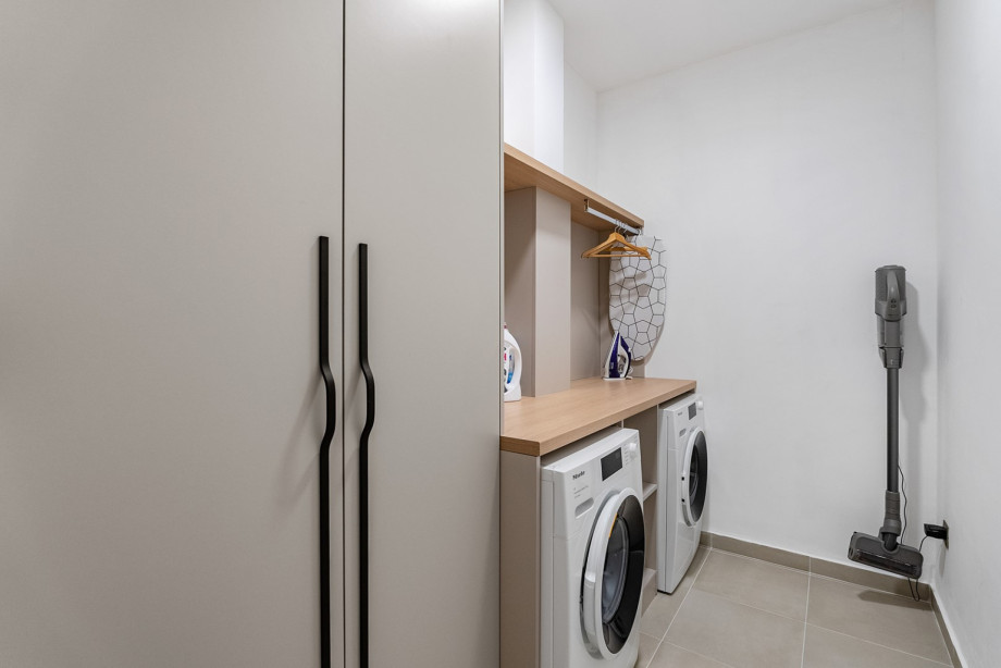 The laundry room is also provided and it offers a washing machine, a dryer and ironing amenities.