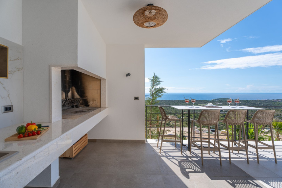 Outdoor dining area with a traditional barbecue