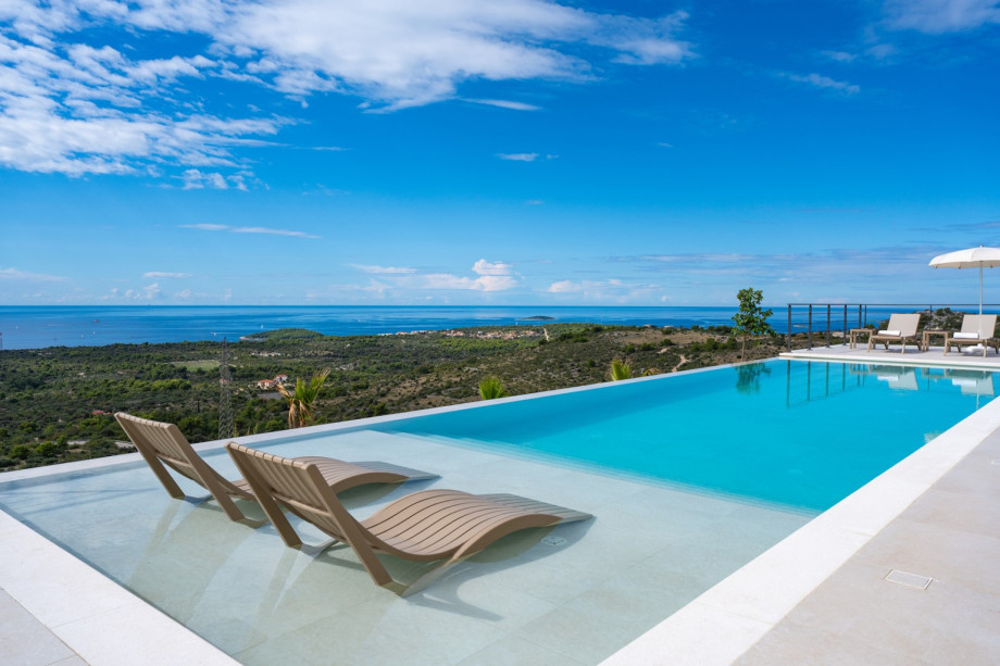 Four cars can park in the private lot, one of which is in the garage, and from there you enter the ground floor living area.