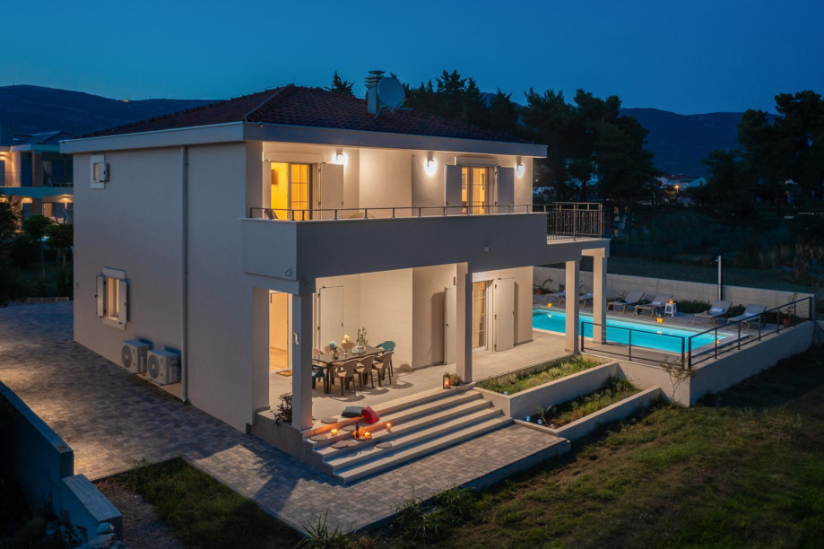 The outdoor area is perfect for families, complete with a playground for little ones, featuring a trampoline, slide, and badminton set