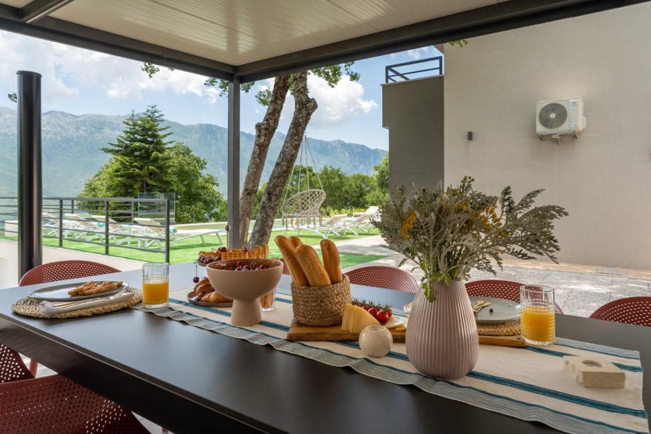 Next to it is a covered outdoor dining area with the traditional barbecue