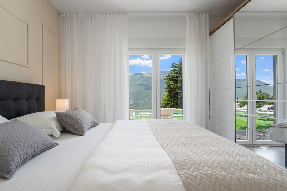 Bedroom No1 with doors toward the pool area