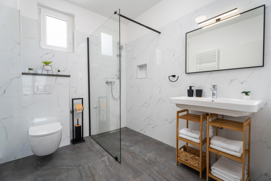 An en-suite bathroom with a shower, a sink, and a toilet