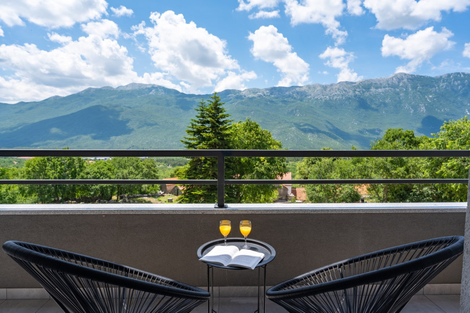 A balcony with outdoor furniture, and shared with Bedroom No2 and No3