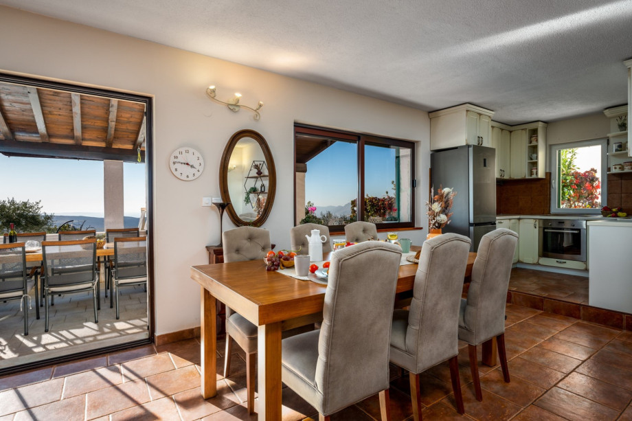 Dining and living room, fully equipped kitchen, TV, fire place and exit to terrace