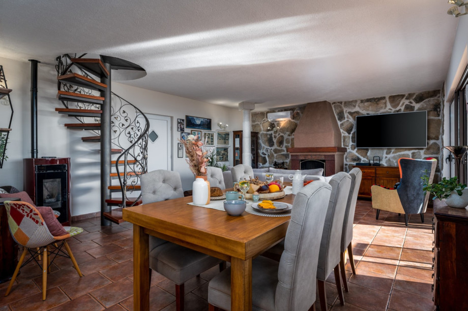 cozy Dining and living room, fully equipped kitchen, TV, fire place and exit to terrace