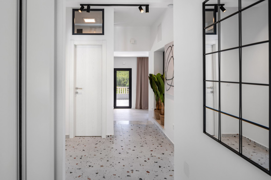 hallway taking you to a spacious and beautifully furnished living room