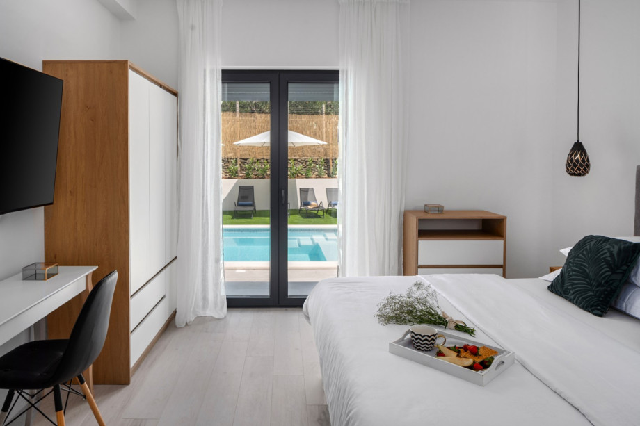 Bedroom NO1 (16sqm) with glass door toward the pool area, A/C, a TV, queen size bed 160cm x 200cm, en-suite bathroom with a shower