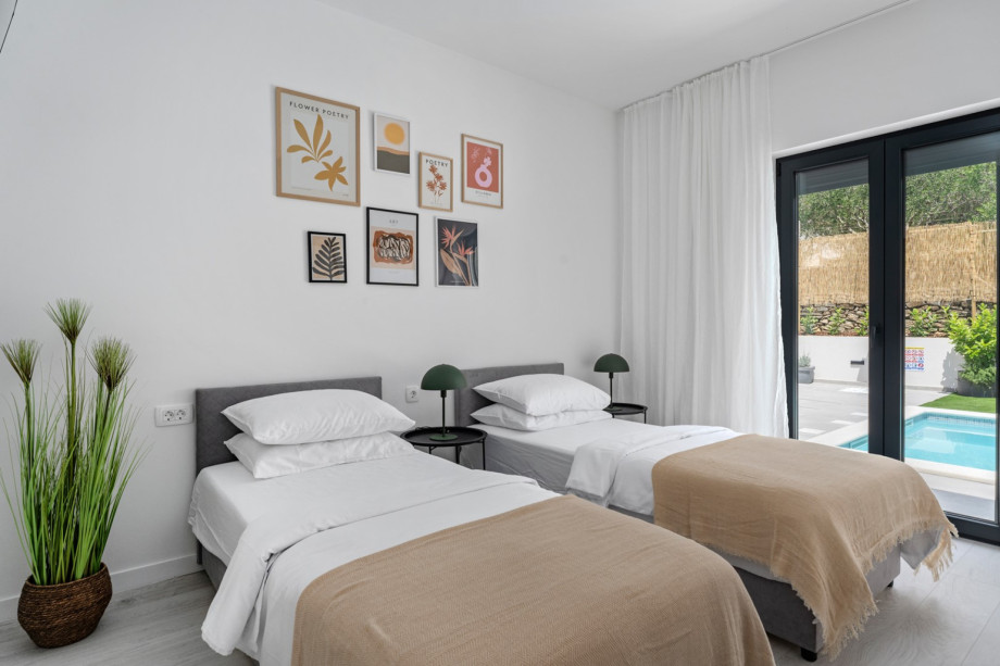 Bedroom NO2 (14sqm) with glass door toward the pool area, A/C, a TV, two single beds 90cm x 200cm that can connect into a king size bed.