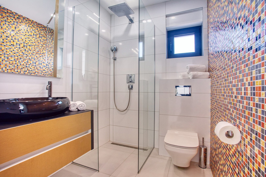 An en-suite bathroom with a shower, a sink, and a toilet