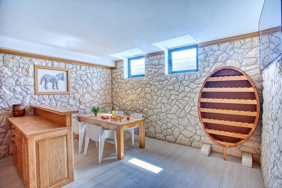 The lower ground floor offers a traditional room with a wooden table