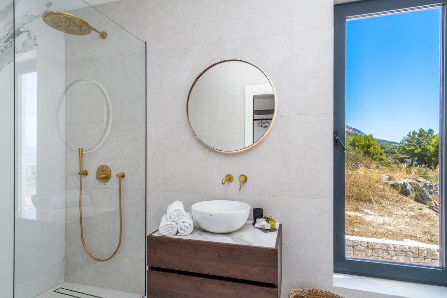 An en-suite bathroom with a shower, a sink, and a toilet