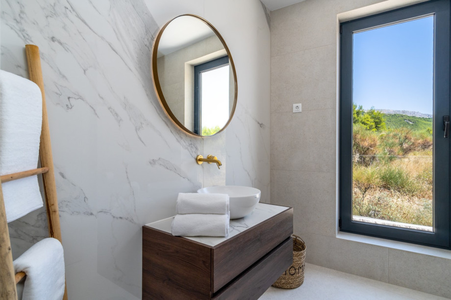 An en-suite bathroom with a shower, a sink, and a toilet