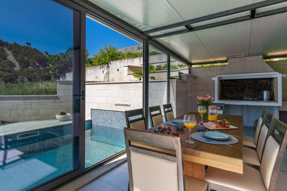 Outdoor dining area with traditional barbecue.