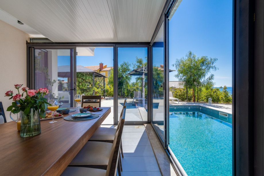 A dining area next to a private swimming pool 9m x 3,5m, 8 deck chairs, and a lounge area.
