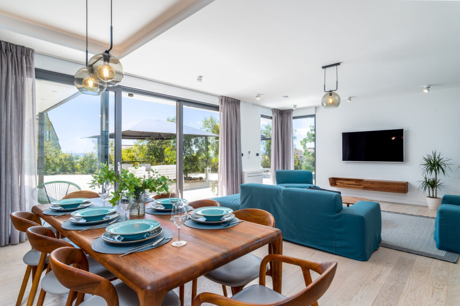 A dining area with floor-to-ceiling glass doors