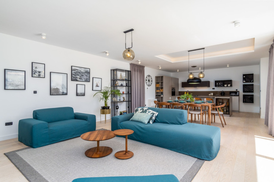 A spacious living room area with a flat-screen TV, PS5, free WiFi