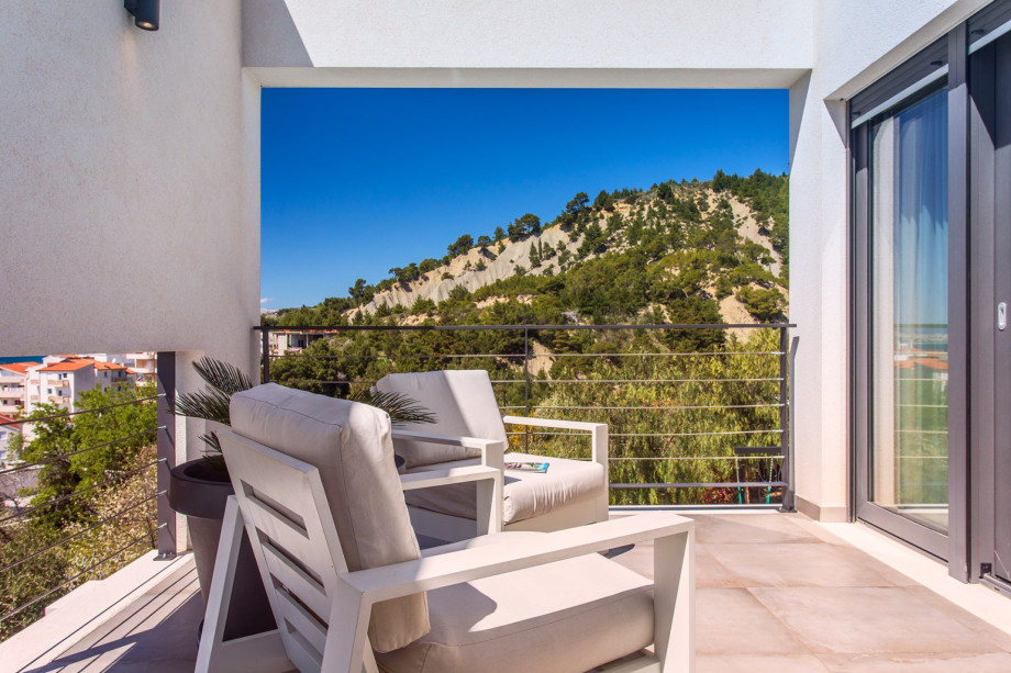 Bedroom No2 also offers a terrace with comfortable outdoor furniture and pool views.