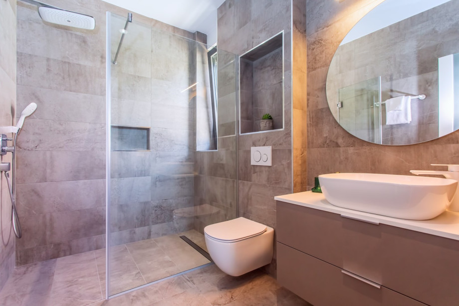 An en-suite bathroom with a shower, a sink, and a toilet.