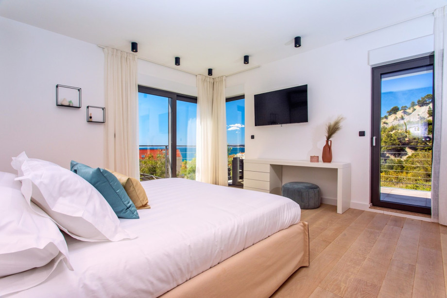Bedroom No4 with views of the pool and the sea.