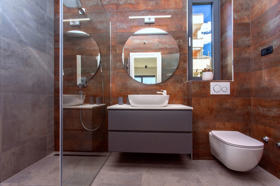 An en-suite bathroom with a shower, a sink, and a toilet.