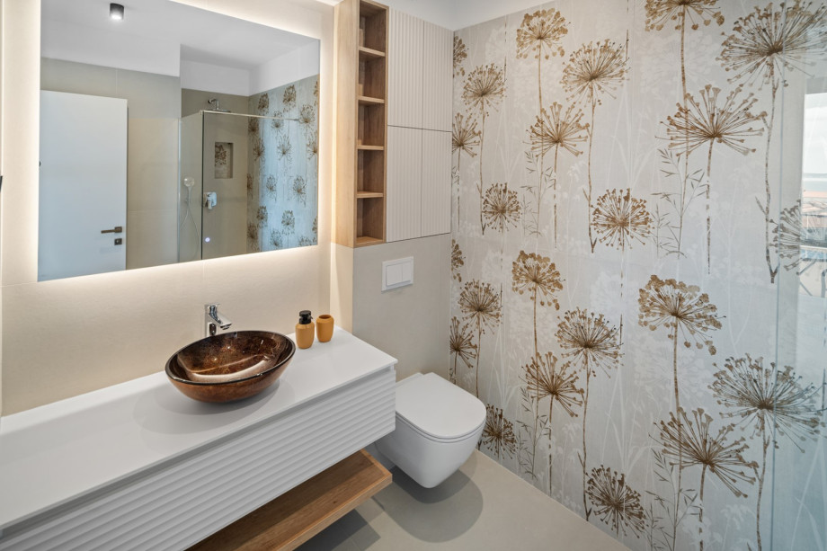 An en-suite bathroom with a shower, a sink, and a toilet