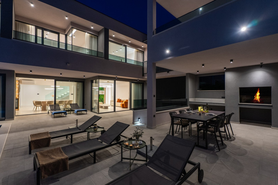 Enjoy the peaceful night outdoors, relaxing on the seating area