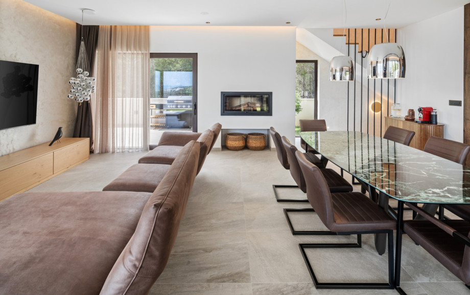 The ground floor features a spacious living area with breathtaking sea views,