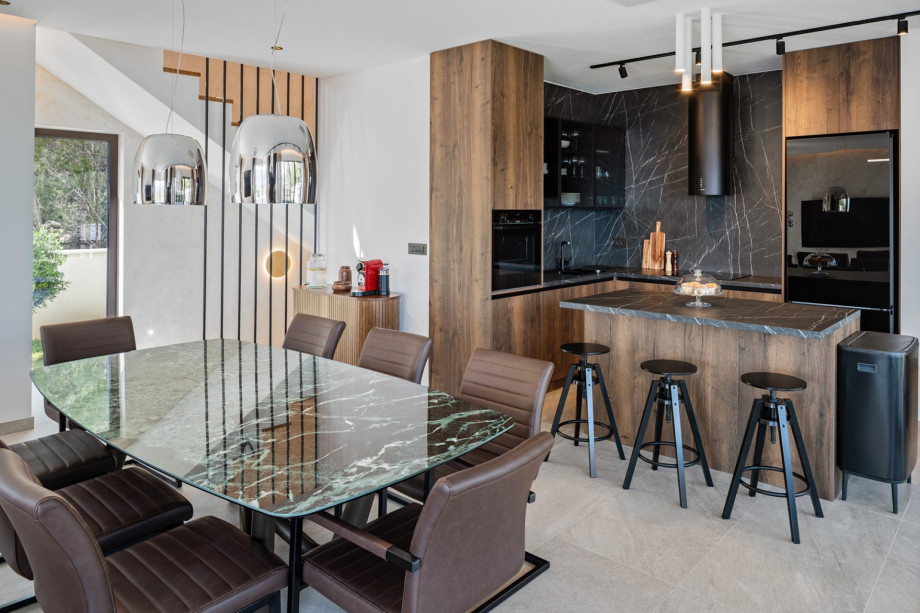 The fully equipped kitchen, complete with a stylish island, serves as a culinary hub